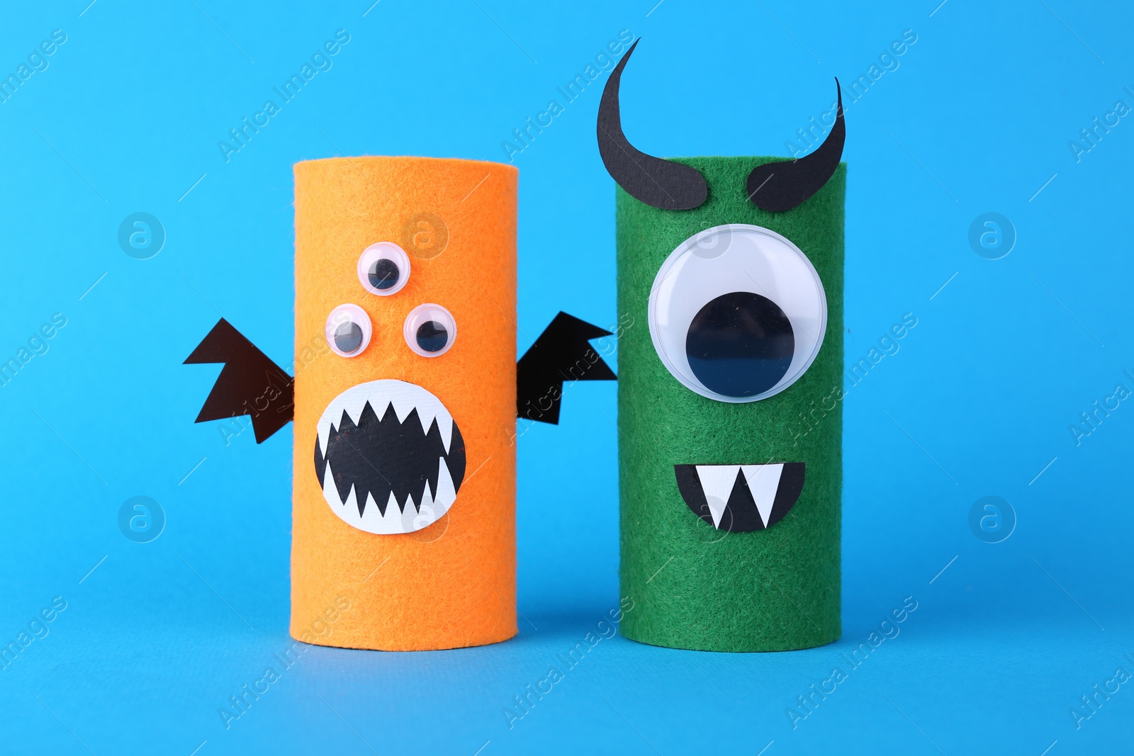 Photo of Spooky monsters on light blue background. Handmade Halloween decoration