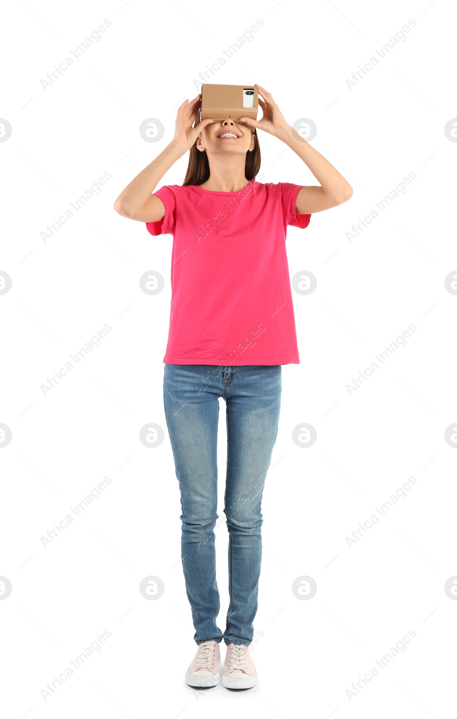 Photo of Young woman using cardboard virtual reality headset, isolated on white