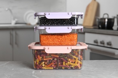 Stacked boxes with different food on table in kitchen