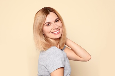 Photo of Portrait of woman with beautiful face on beige background