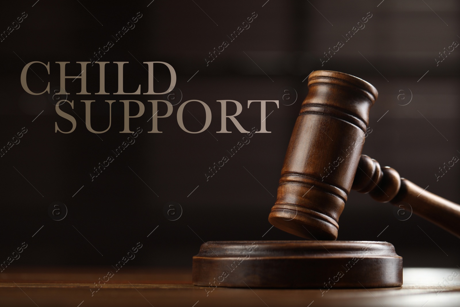 Image of Judge's gavel on wooden table, closeup. Child support concept