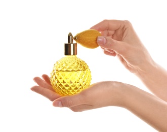 Photo of Woman holding bottle of luxury perfume on white background, closeup