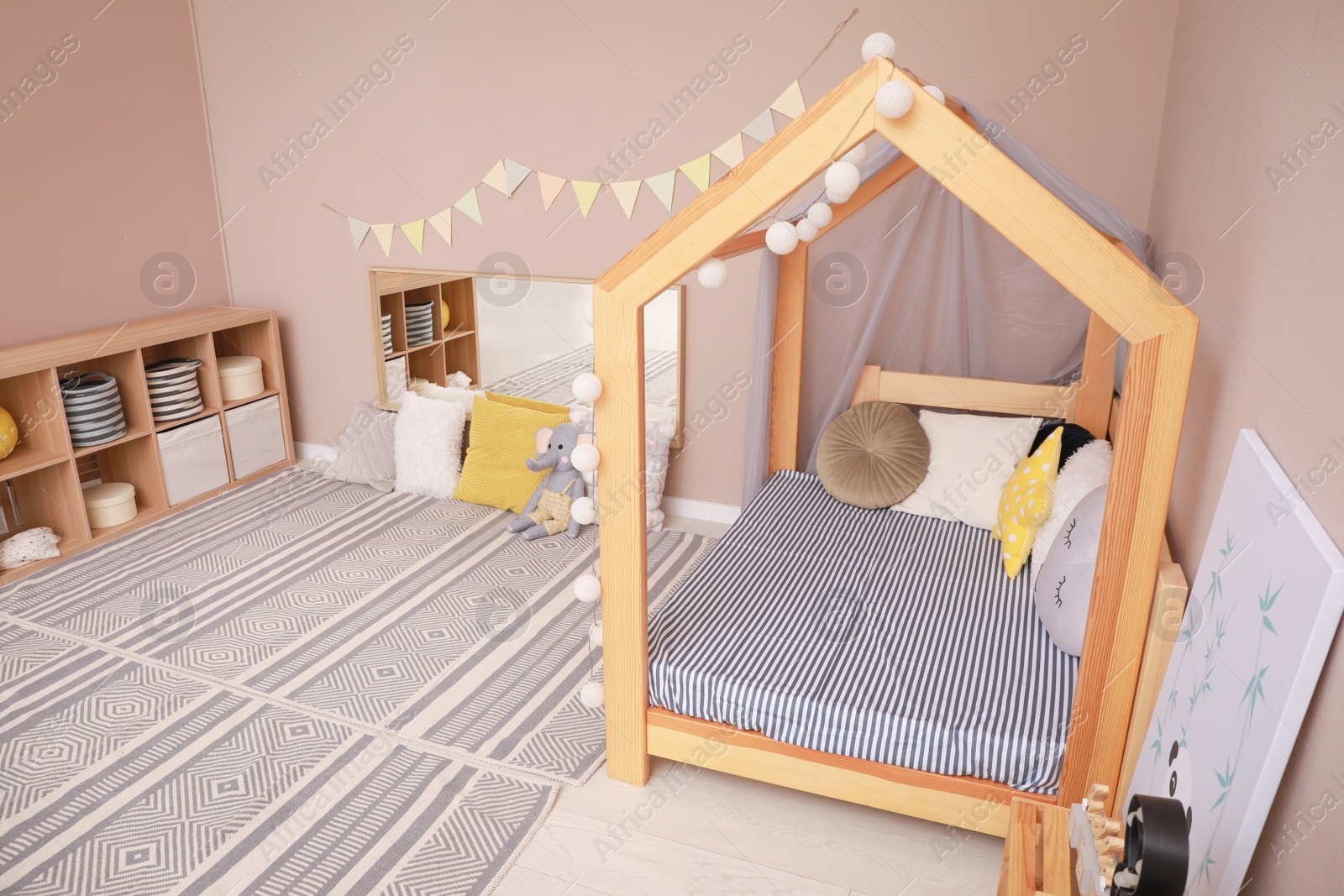 Photo of Stylish child room interior with comfortable floor bed