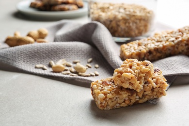 Photo of Homemade grain cereal bar on table, closeup. Healthy snack