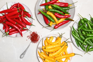 Photo of Flat lay composition with chili peppers on light background