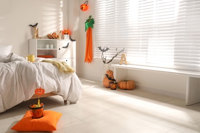 Photo of Stylish bedroom interior with festive Halloween decor