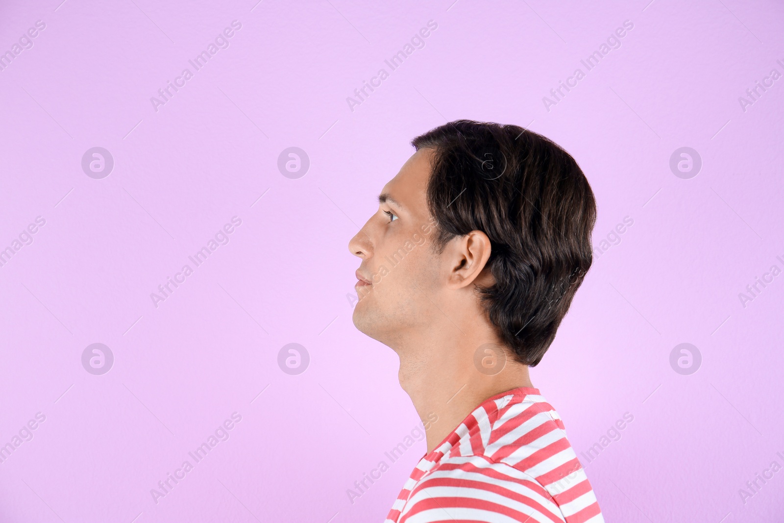 Photo of Young man on color background with copy space text. Hearing problem