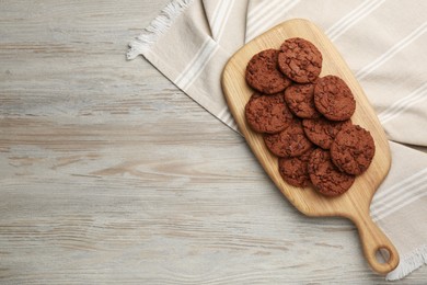 Delicious chocolate chip cookies on light wooden table, top view. Space for text