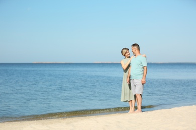 Photo of Happy mature couple at beach on sunny day
