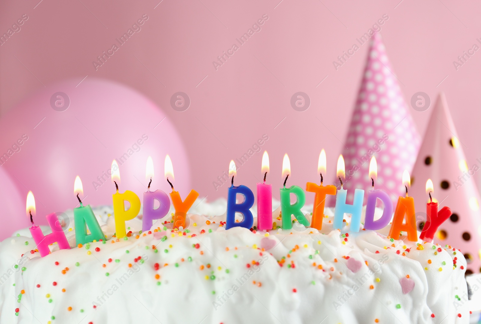 Photo of Birthday cake with burning candles on pink background, closeup