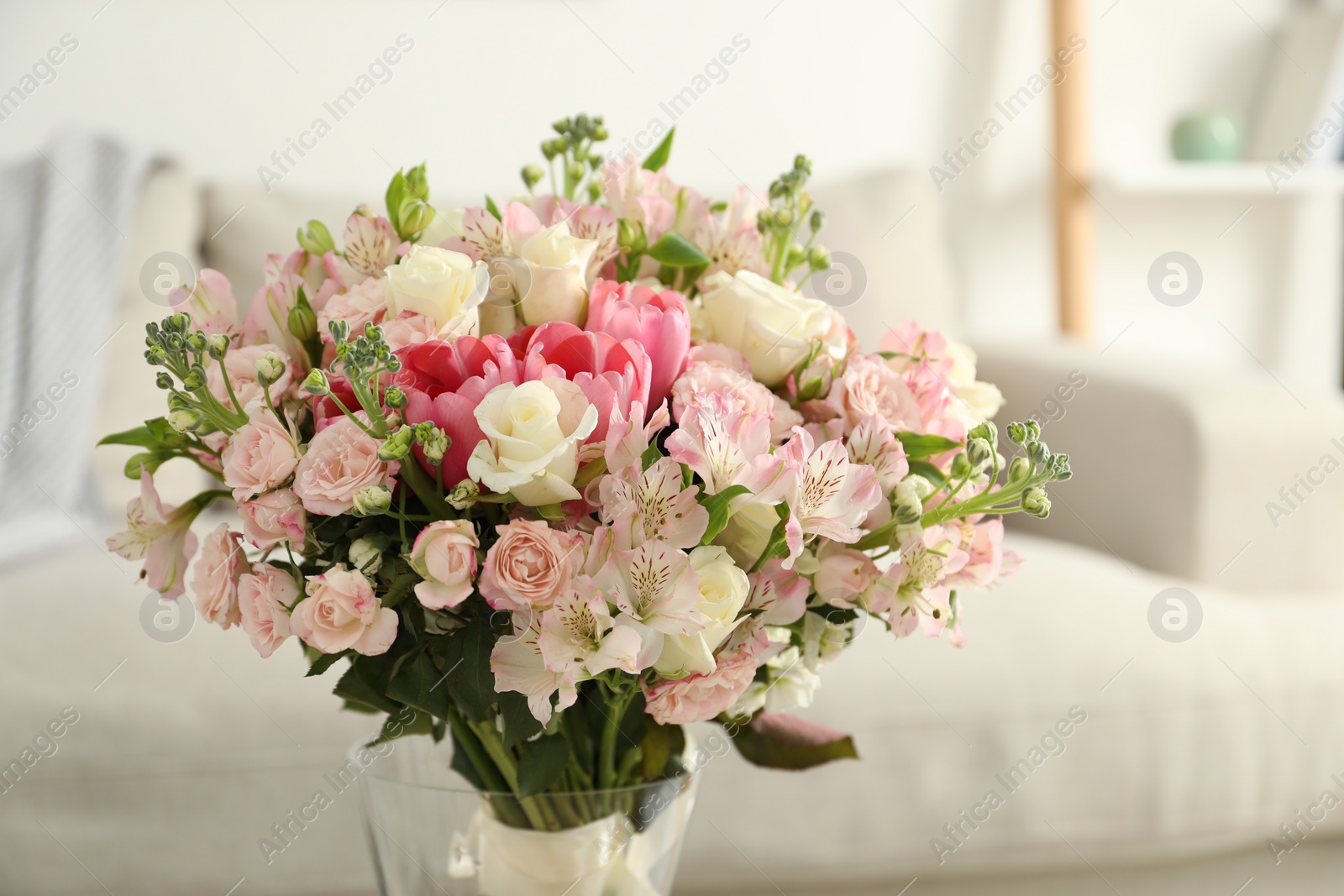 Photo of Beautiful bouquet of fresh flowers in vase indoors