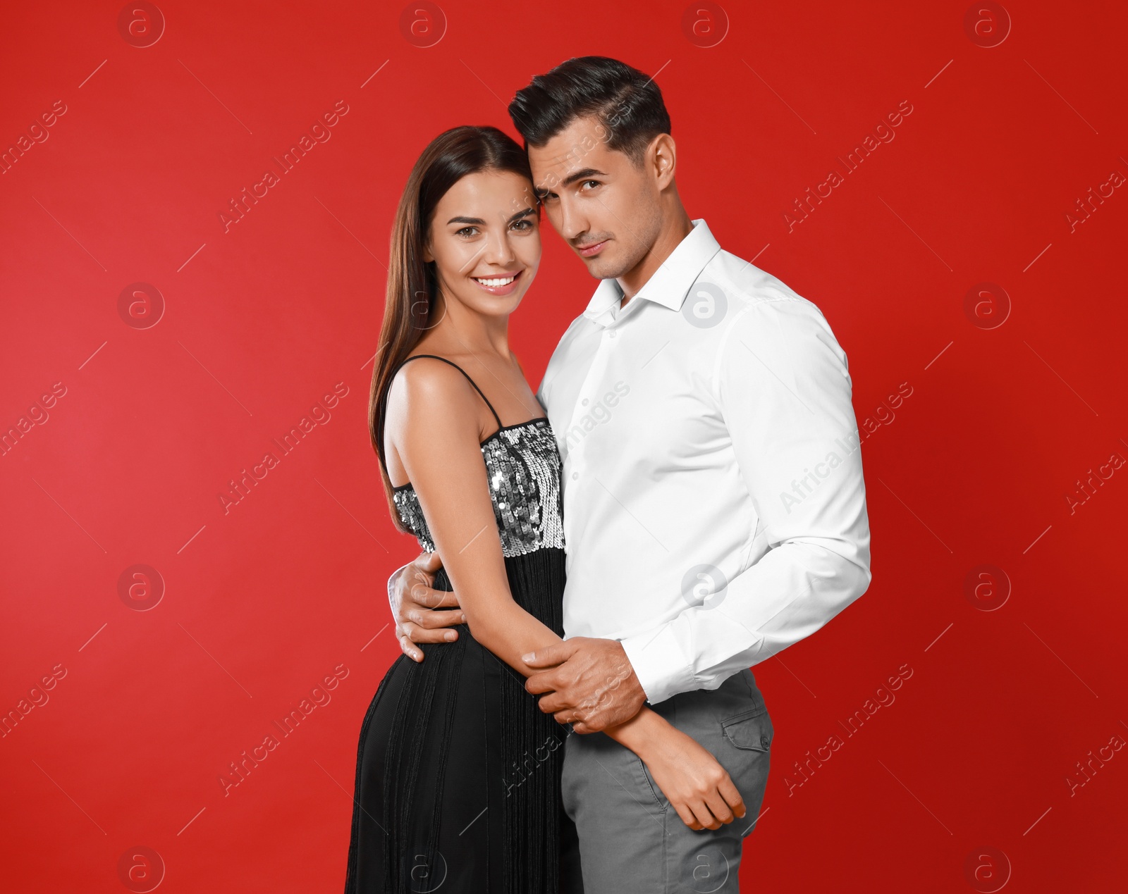 Photo of Portrait of beautiful couple on red background