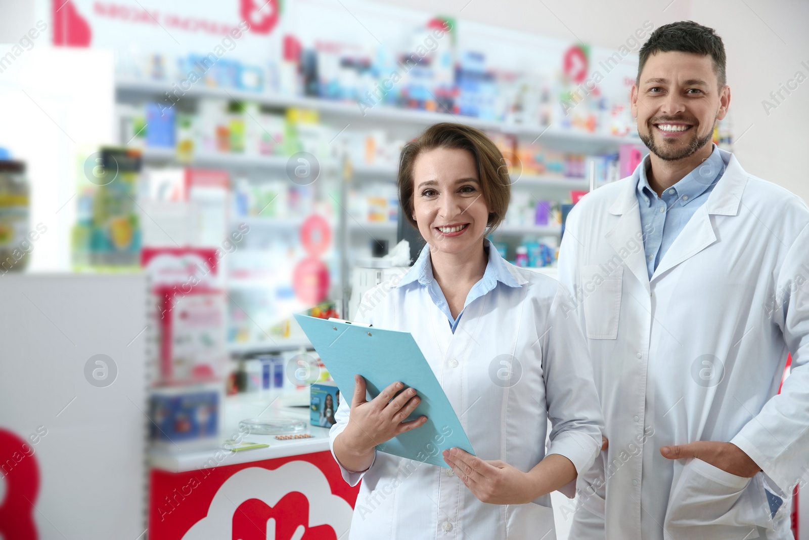 Photo of Portrait of professional pharmacists in modern drugstore