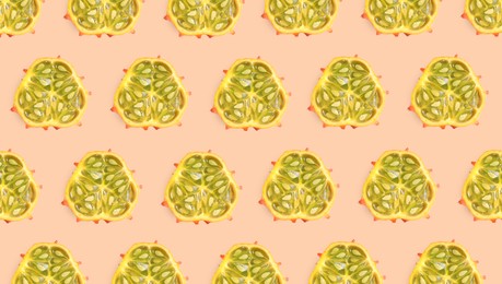 Cut exotic kiwano fruits on beige background, flat lay. Banner design