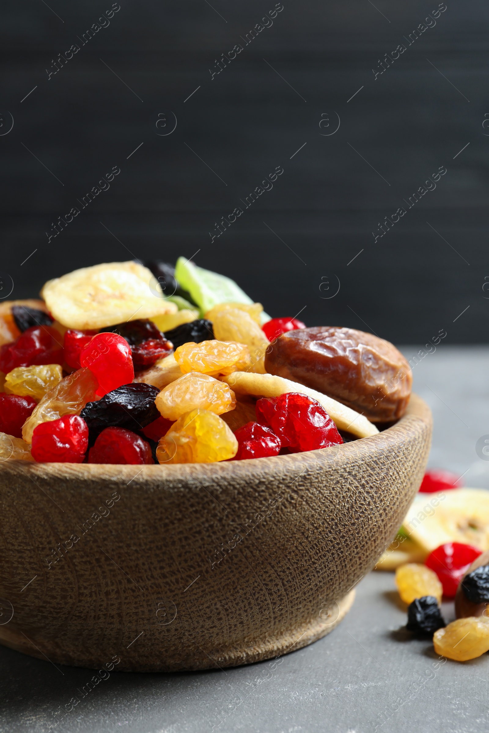 Photo of Bowl with different dried fruits on table, closeup. Healthy lifestyle
