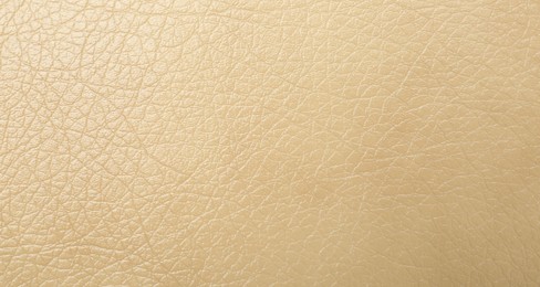 Texture of beige leather as background, closeup