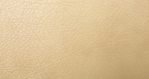 Photo of Texture of beige leather as background, closeup