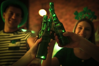 Photo of People with beer celebrating St Patrick's day in pub, closeup