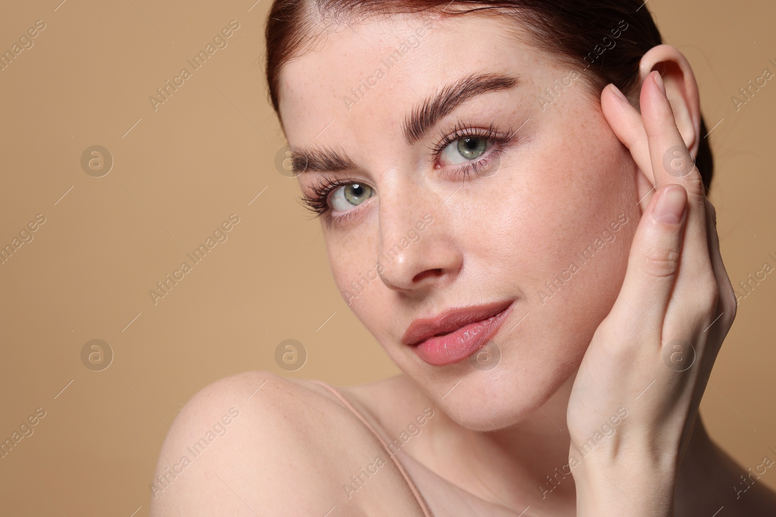 Photo of Portrait of beautiful woman on beige background, closeup