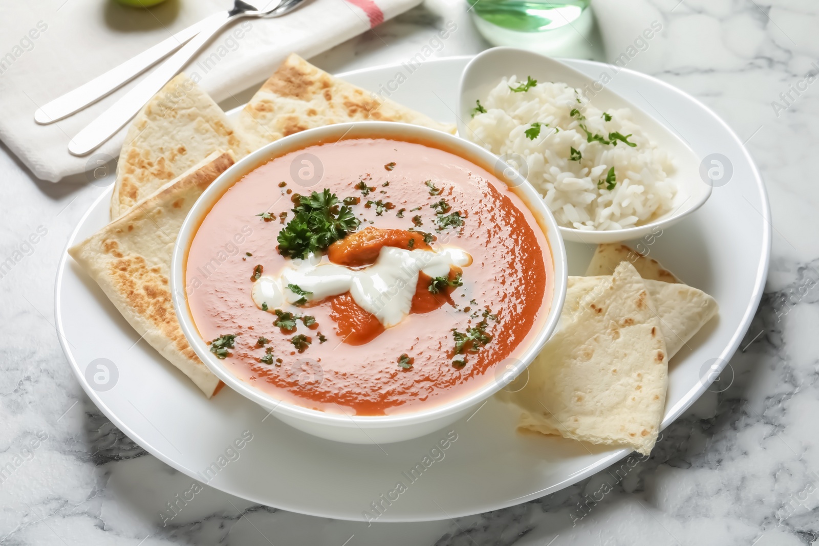 Photo of Delicious butter chicken served on table. Traditional Murgh Makhani dish