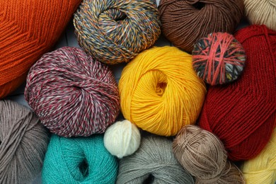 Photo of Many different soft woolen yarns as background, top view