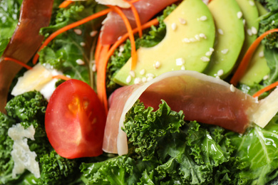 Photo of Delicious kale salad with prosciutto as background, closeup