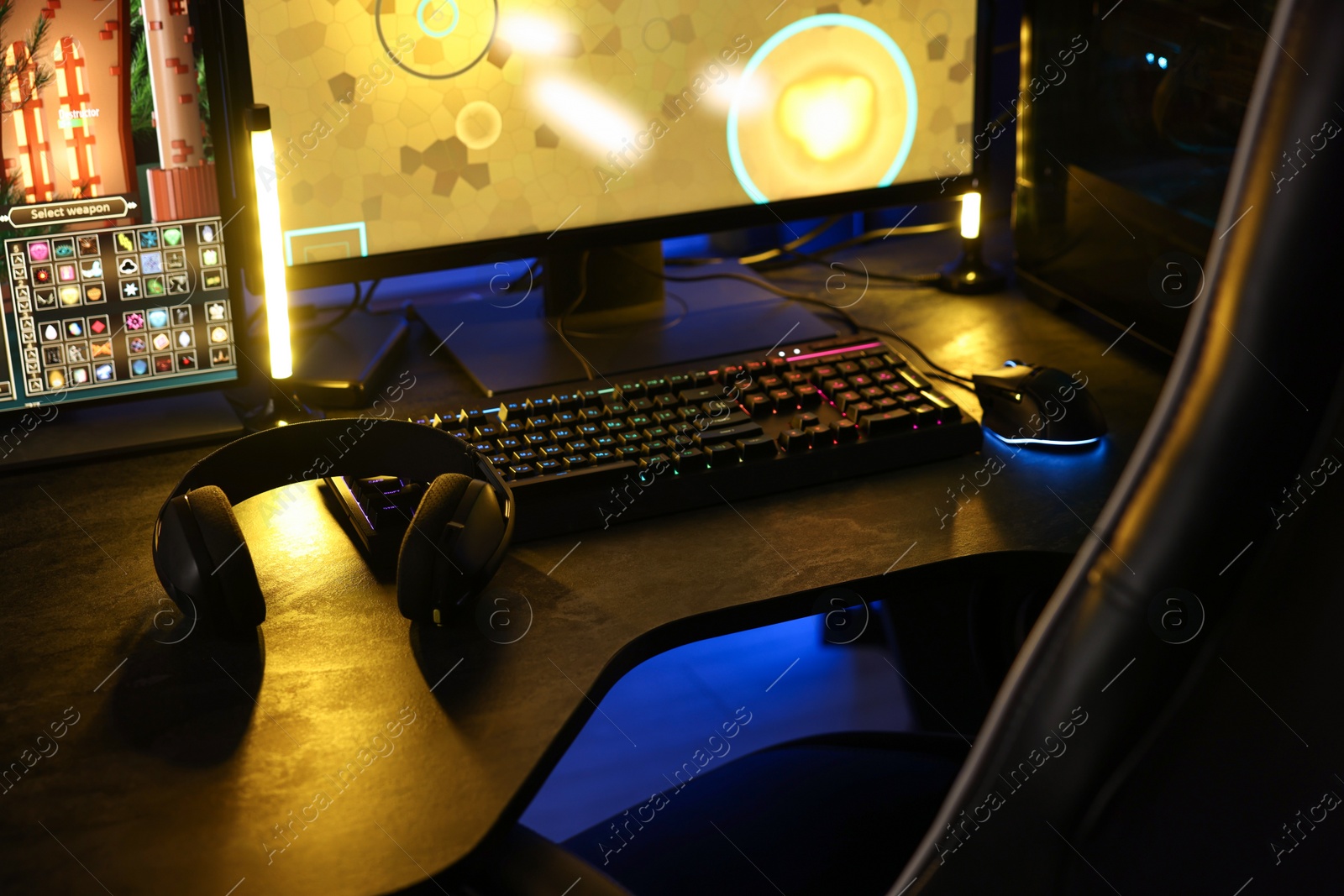 Photo of Playing video games. Computer monitor, keyboard, mouse and headphones on table indoors