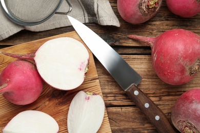 Photo of Red raw turnips on wooden table, flat lay