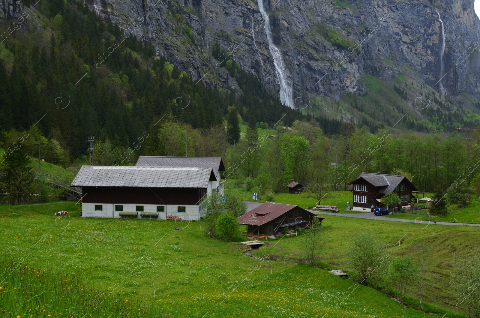 Photo of View of beautiful cottages on green hill in mountains