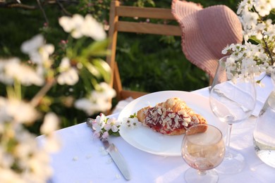 Photo of Stylish table setting with beautiful spring flowers in garden