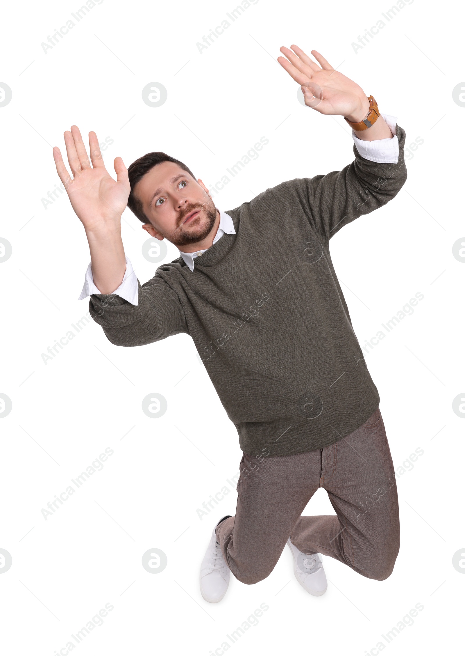 Photo of Handsome bearded businessman evading something on white background, above view