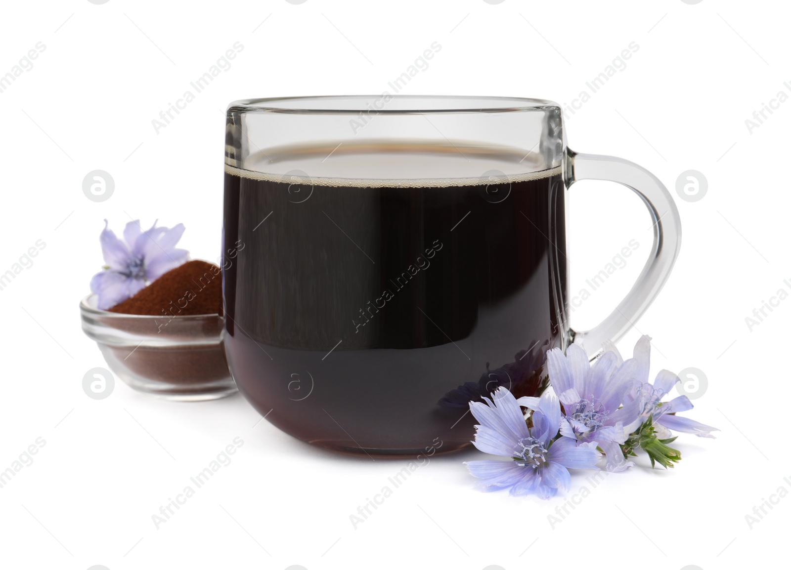 Photo of Glass cup of delicious chicory drink, powder and flowers on white background