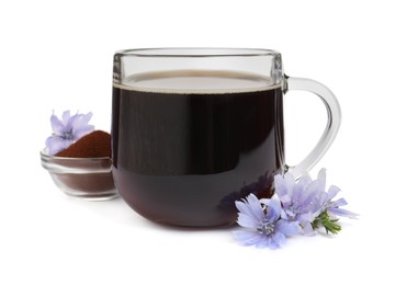 Photo of Glass cup of delicious chicory drink, powder and flowers on white background
