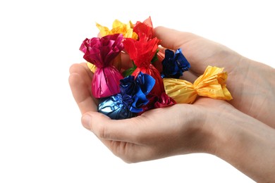 Photo of Woman holding heap of candies in colorful wrappers isolated on white, closeup