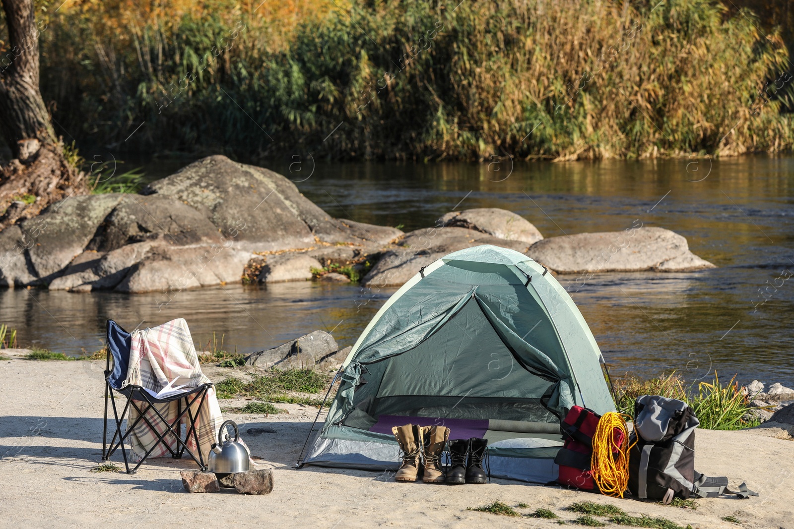 Photo of Set of equipment near camping tent outdoors