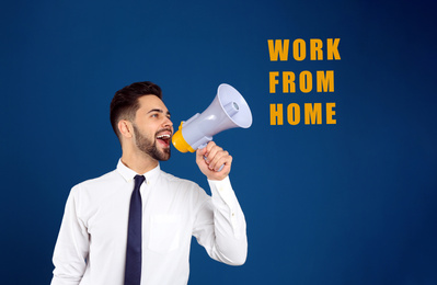 Image of Young man with megaphone on blue background. Work from home during coronavirus outbreak