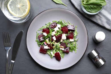 Delicious beet salad served on black table, flat lay