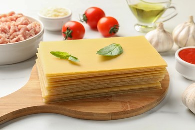 Ingredients for lasagna on white marble table