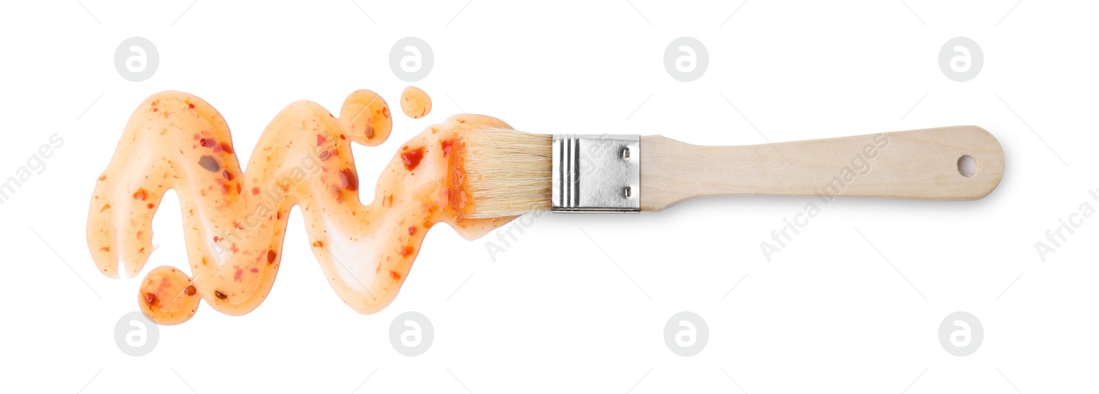 Photo of Basting brush with fresh marinade isolated on white, top view