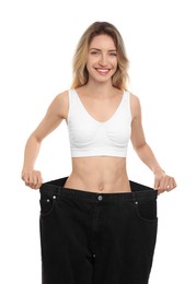 Photo of Young woman wearing big jeans after weight loss on white background