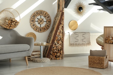 Photo of Stylish room interior with firewood as decorative element