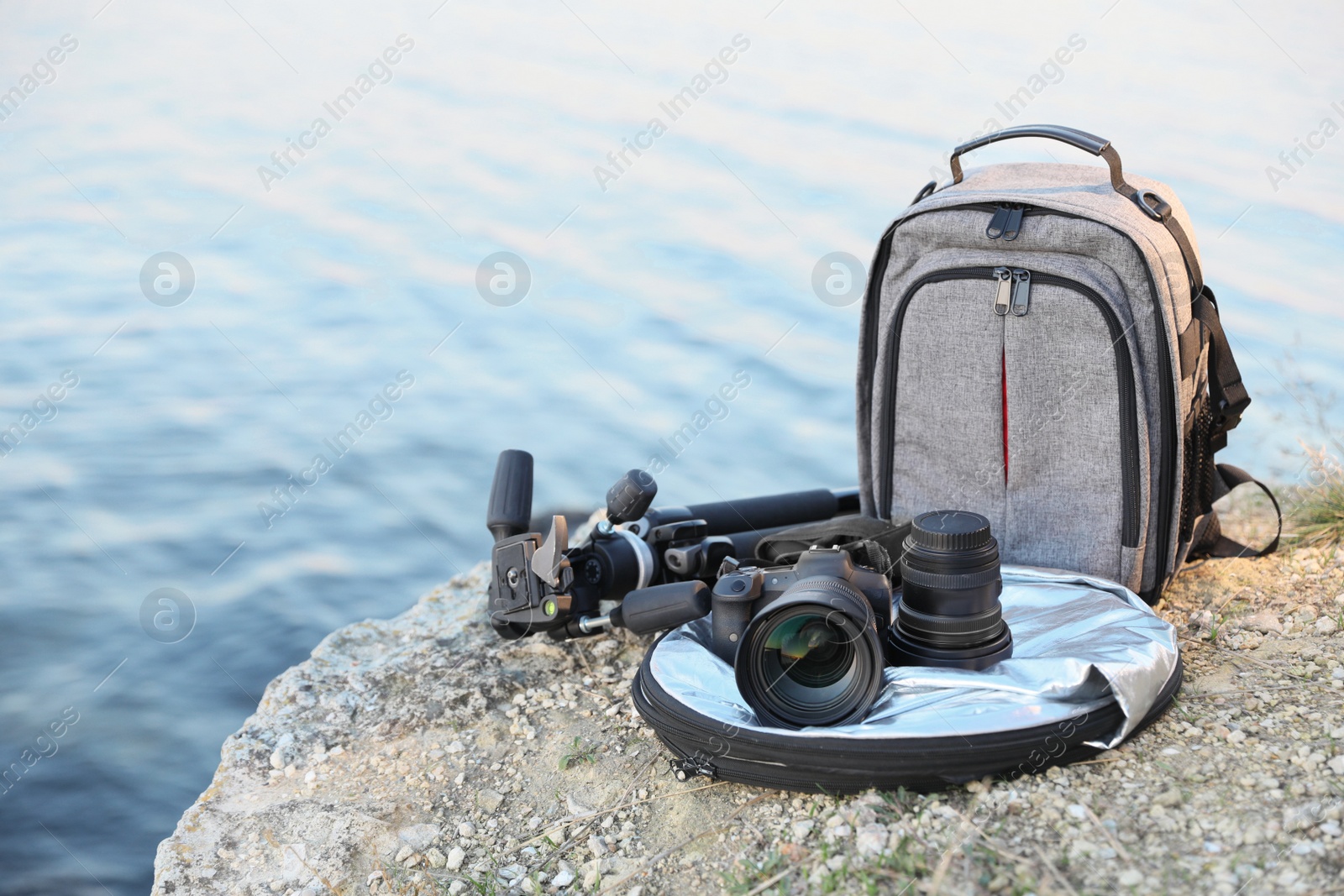 Photo of Professional photography equipment on rocky river coast