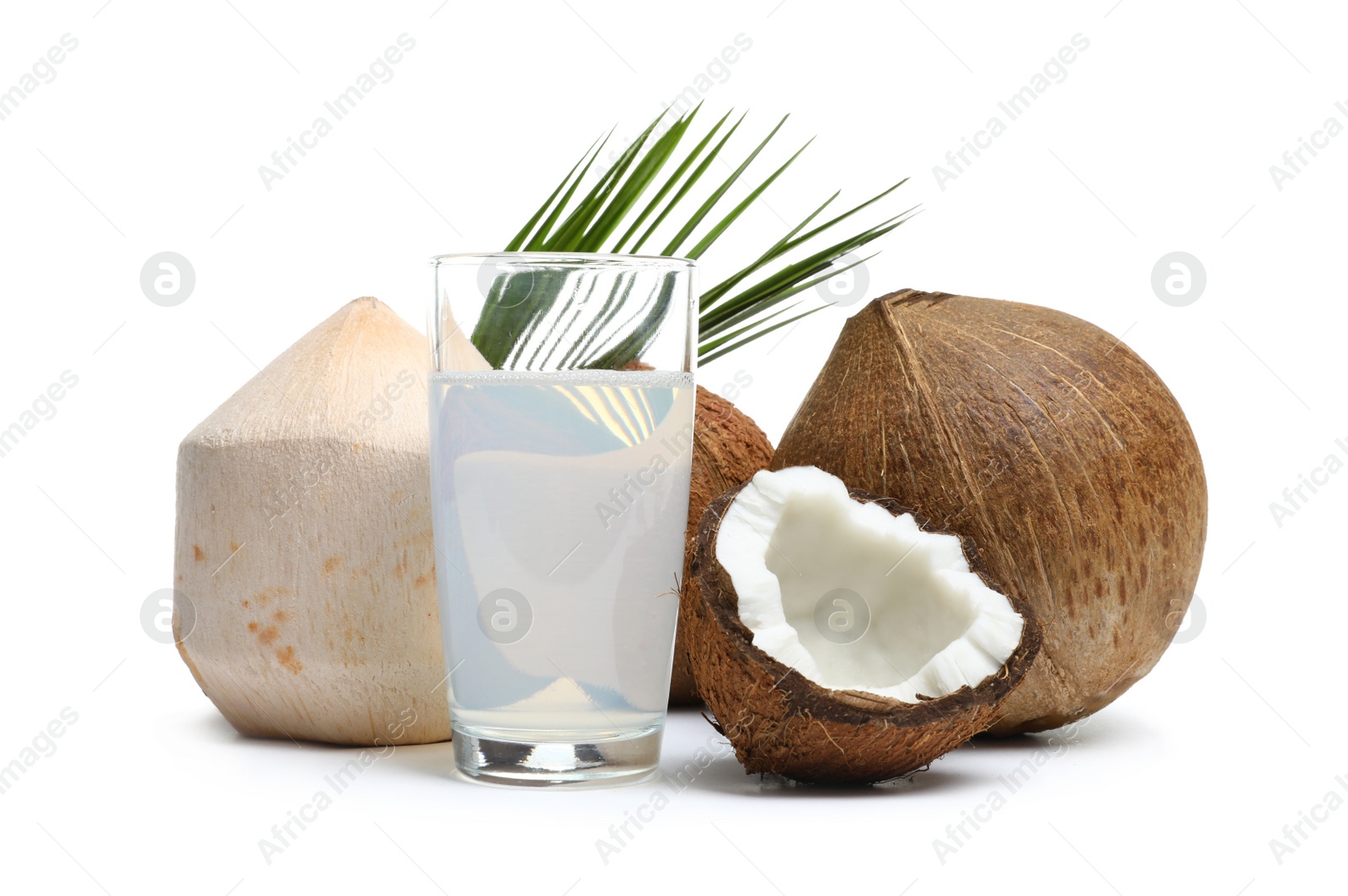 Photo of Glass of coconut milk and nuts on white background