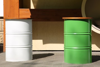 Photo of Beautiful view of outdoor cafe with barrels as tables on sunny day