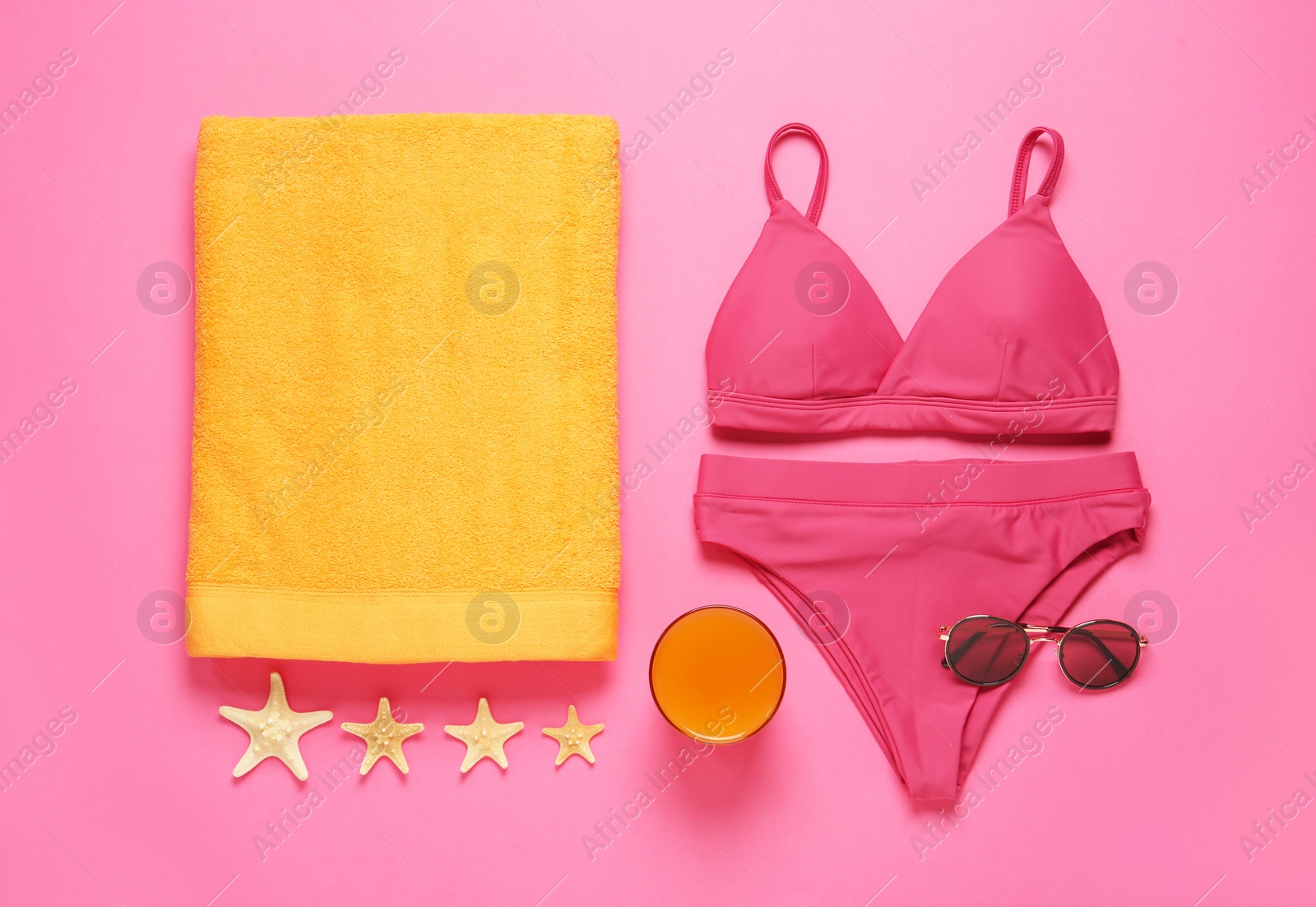 Photo of Flat lay composition with different beach objects on pink background