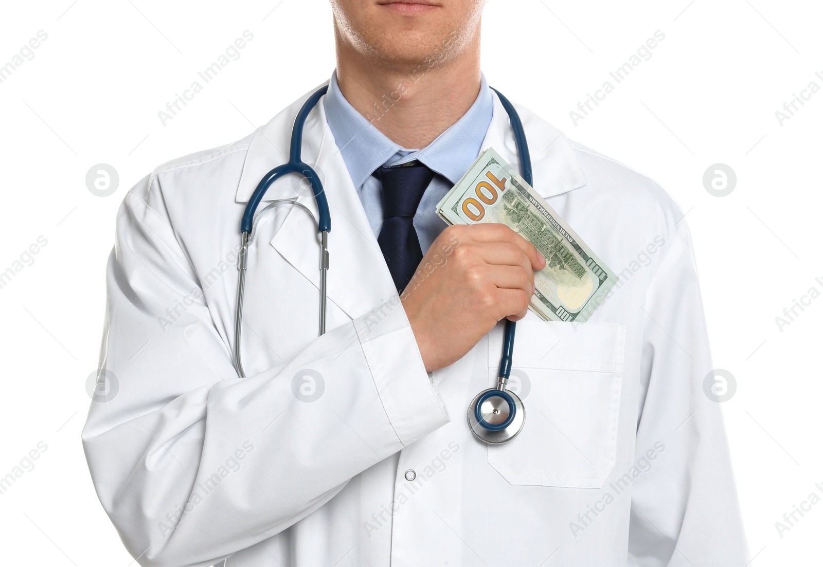 Photo of Doctor putting bribe into pocket on white background, closeup. Corruption in medicine