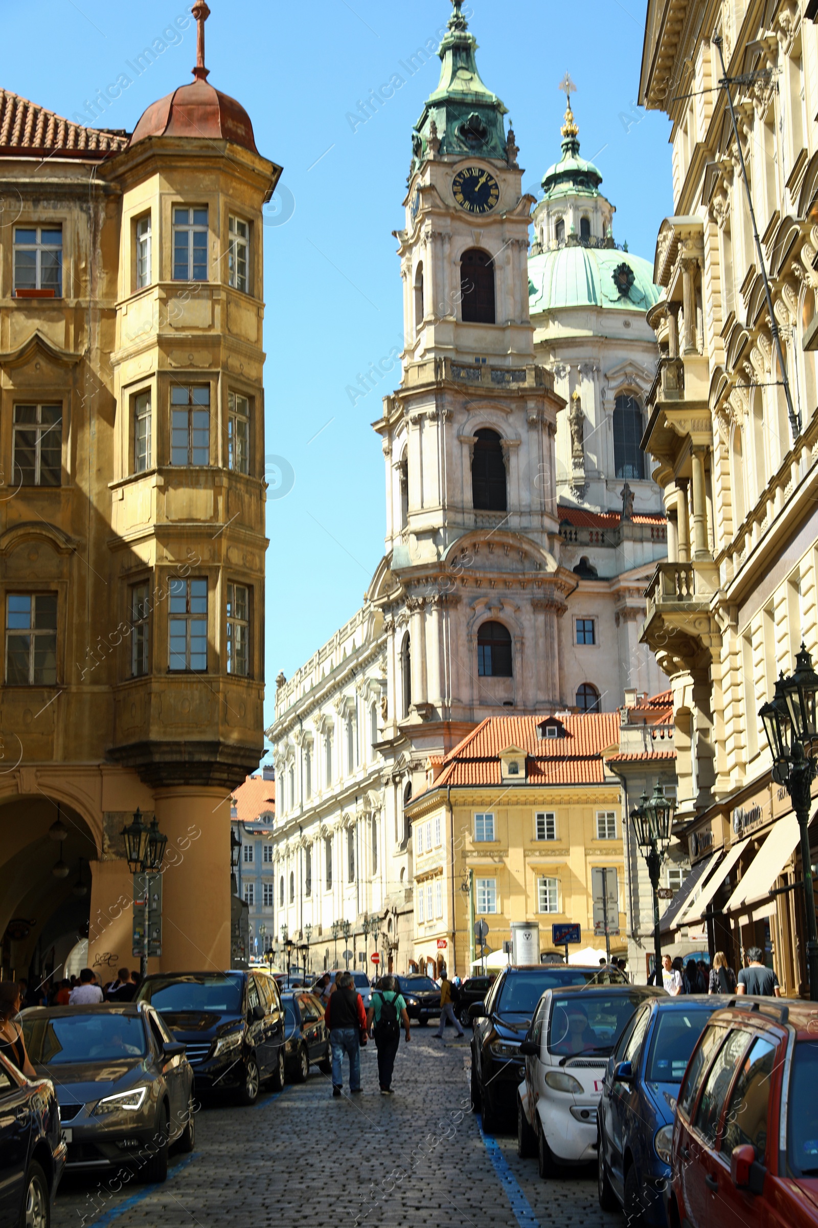 Photo of PRAGUE, CZECH REPUBLIC - APRIL 25, 2019: City street with Saint Nicholas Church