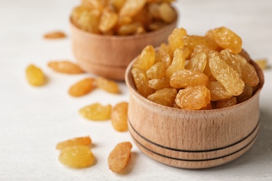 Bowl with raisins on table, space for text. Dried fruit as healthy snack