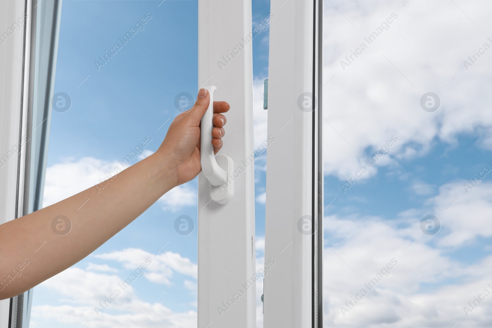 Photo of Woman opening white plastic window at home, closeup