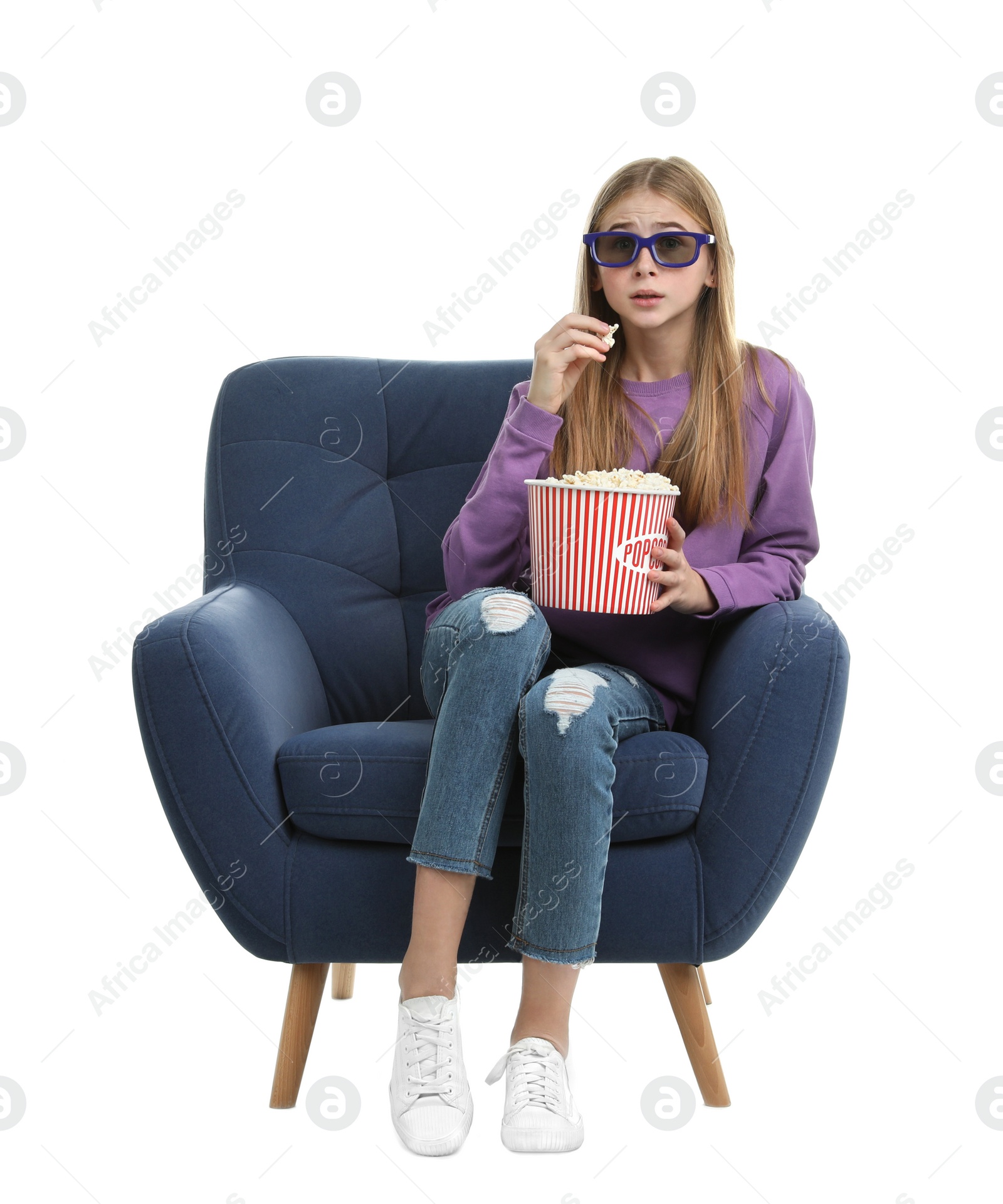 Photo of Emotional teenage girl with 3D glasses and popcorn sitting in armchair during cinema show on white background